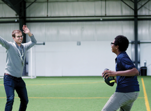 STRIVE Prep teacher and student throwing a football